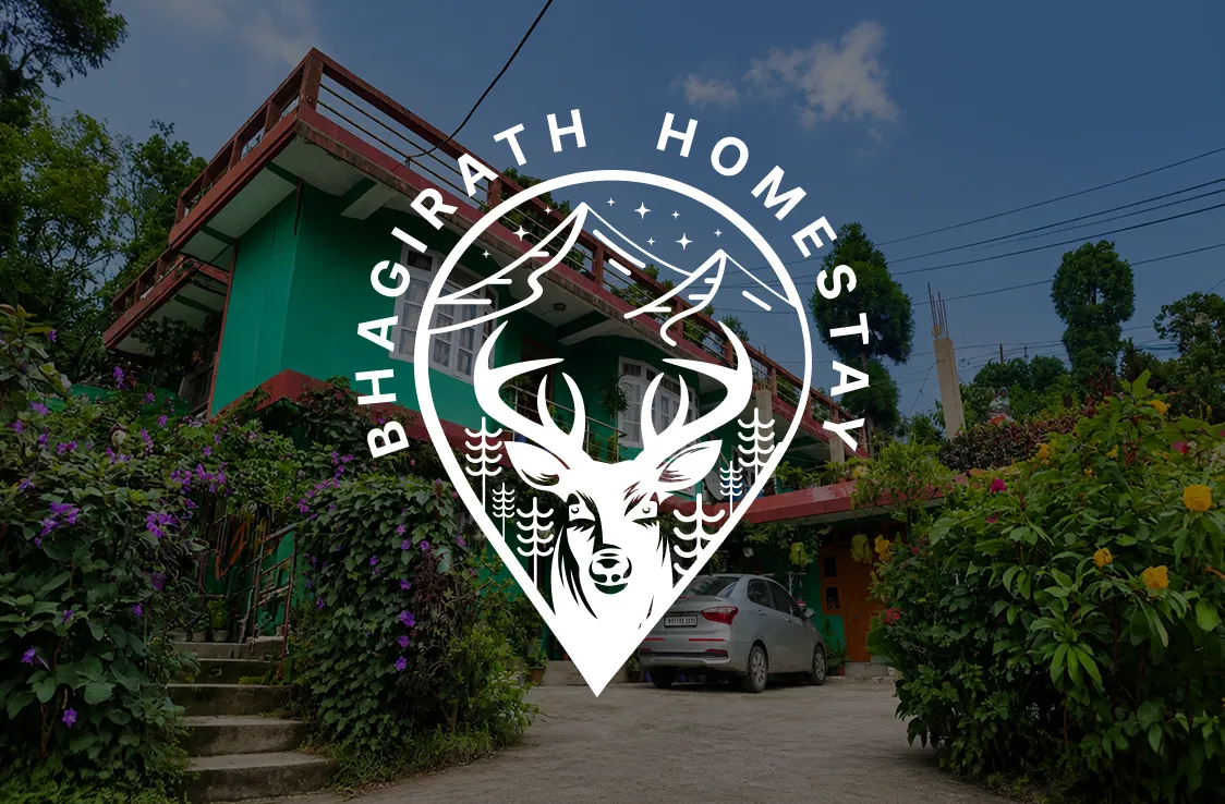Bhagirath Homestay in Mirik — the green hillside guesthouse behind the brand's deer-and-mountain pin emblem