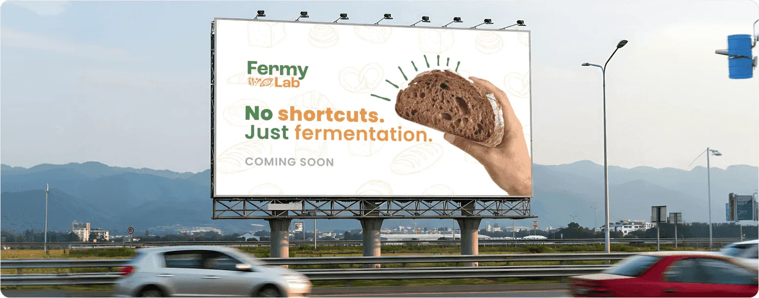 Highway billboard — oversized food photography paired with the minimal line "No shortcuts. Just fermentation."